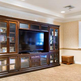 Spacious living room with a large entertainment center and television.