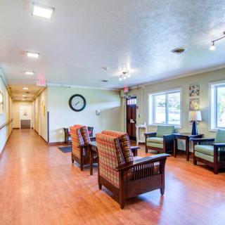 A bright and spacious waiting area with comfortable seating and large windows.