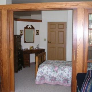 A cozy bedroom with wooden furniture and a floral bedspread.