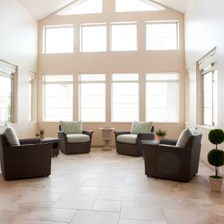 A modern living room with ample natural light and stylish furniture.