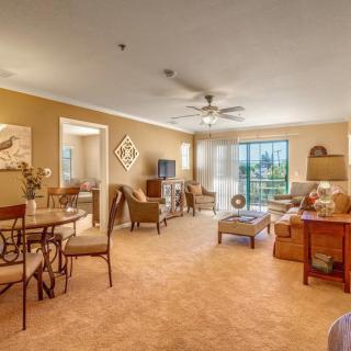 Cozy living room with warm lighting and an open dining area.