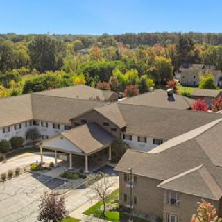A scenic aerial view of a residential community surrounded by autumn foliage.