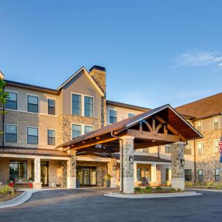 A hotel building with a welcoming entrance under a clear blue sky.