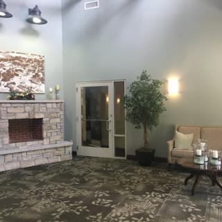 A cozy lobby space featuring a stone fireplace and comfortable seating.