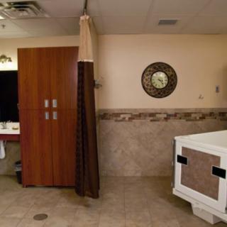 A modern bathroom interior with a bathtub, mirror, and curtain.