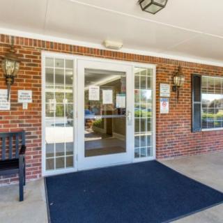 An entrance with glass doors and a brick exterior.