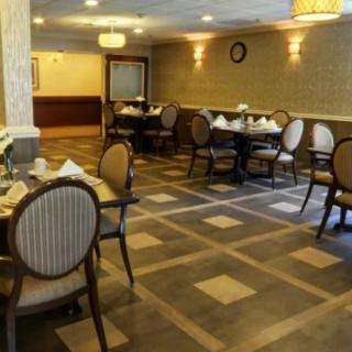 Empty restaurant dining area with neatly arranged tables and chairs.