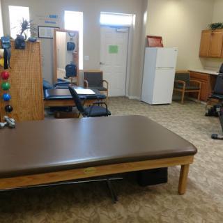 A view of a well-organized therapy room equipped for rehabilitation.