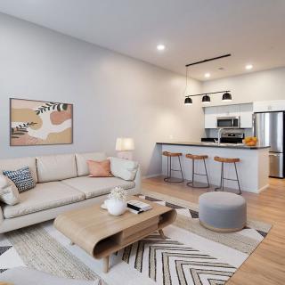 A modern open-plan living room and kitchen with stylish decor and comfortable seating.