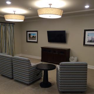 A cozy living room with modern furniture, soft lighting, and decorative artwork.