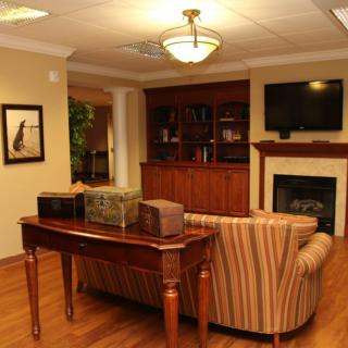A cozy living room with a fireplace, television, and comfortable seating.