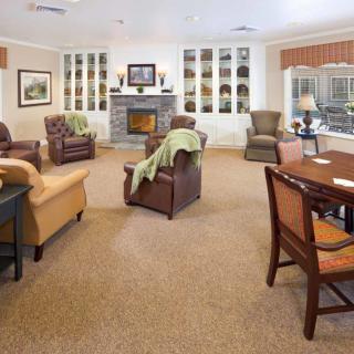 A cozy living room with comfortable seating and a fireplace.