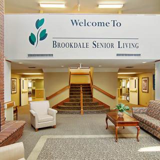 Lobby area of Brookdale Senior Living with welcoming furniture and a sign.