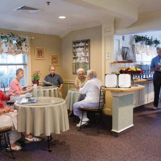 A group of seniors socializing in a cozy common area.