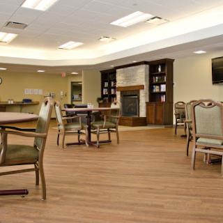 A cozy community lounge featuring comfortable seating, a warm fireplace, and an inviting atmosphere.
