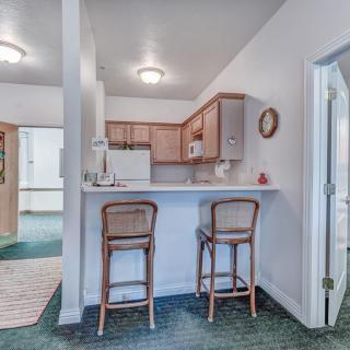 A compact kitchen with bar seating in an open-plan apartment.