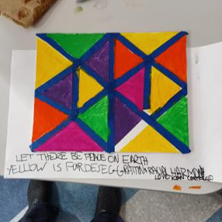 A colorful geometric artwork featuring triangles in various vibrant colors.