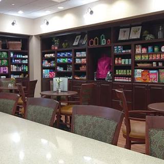 A cozy cafe with bookshelves, tables, and chairs for customers.