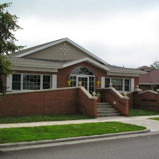 A charming brick house with a landscaped front yard.