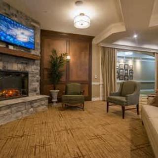 A cozy living room with a fireplace, television, and comfortable seating area.