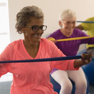 A group of seniors enjoying a fitness class using resistance bands.