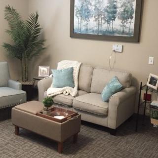 A cozy living room with a sofa, coffee table, and decorative elements.