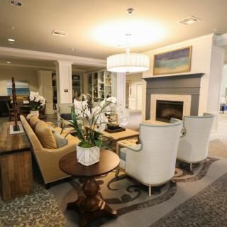 A modern and cozy living room featuring a fireplace, elegant furniture, and tasteful decor.