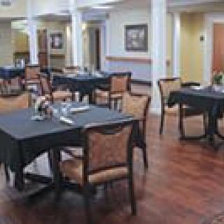 A cozy dining area with neatly set tables and chairs.