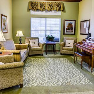 Cozy living room with armchairs, a window, and stylish decor.