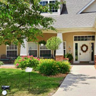 A charming suburban house with a well-maintained front yard and inviting porch.
