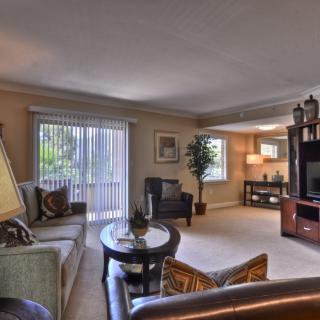 A cozy living room featuring a comfortable seating arrangement, stylish decor, and ample natural light.