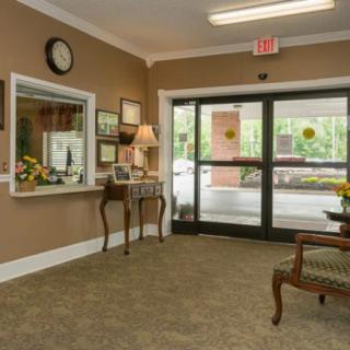 A cozy reception area with a front desk, comfortable seating, and elegant decor.
