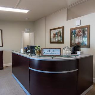 A stylish and modern office reception area with decorative artwork.