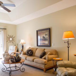 A cozy living room with comfortable seating and warm lighting.