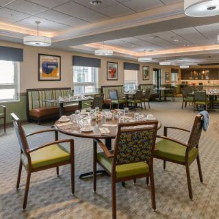 An elegantly set dining area with neatly arranged tables and chairs.
