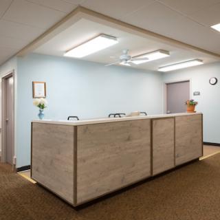 A modern reception desk in a well-lit office environment.