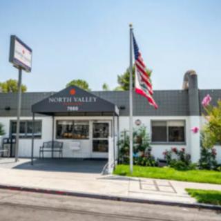 A building with an American flag and an awning at the entrance.