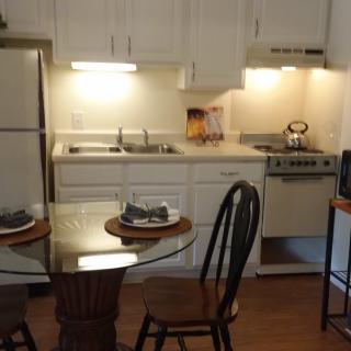 Cozy kitchen with a dining area, featuring a small table and chairs.