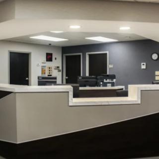 A modern and clean office reception area with a central desk.