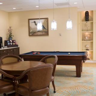 A cozy game room featuring a pool table and seating area.