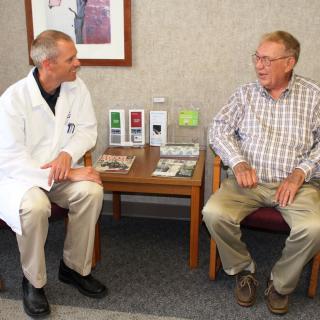 A doctor and a patient having a conversation in a medical office.