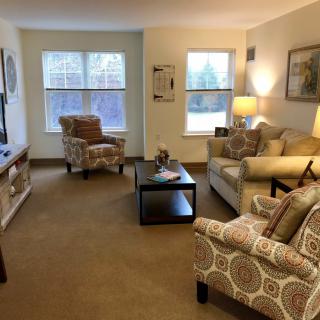 Cozy living room with comfortable seating and warm lighting.