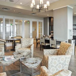 A modern, cozy lounge area with comfortable seating and elegant lighting.