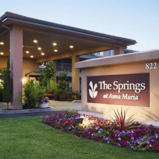 Entrance of The Springs at Anna Maria with illuminated signage and well-maintained landscaping.