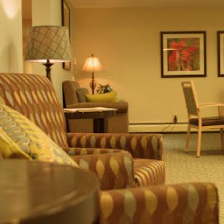 A cozy lounge area featuring stylish seating and warm lighting.
