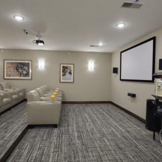 A cozy home theater with comfortable seating and a large projector screen.