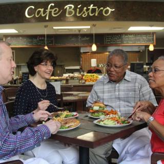 A group of friends enjoying a meal at Cafe Bistro.