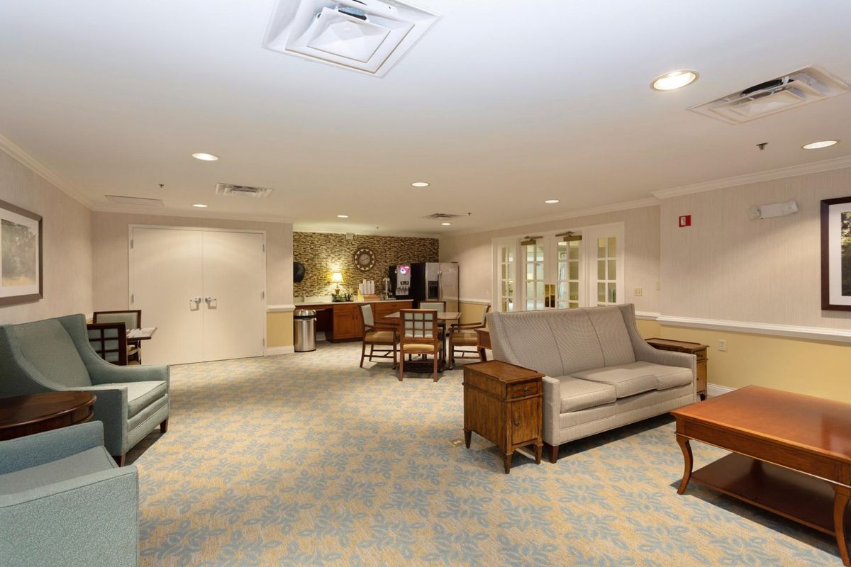 A spacious living room with cozy furniture and warm lighting.