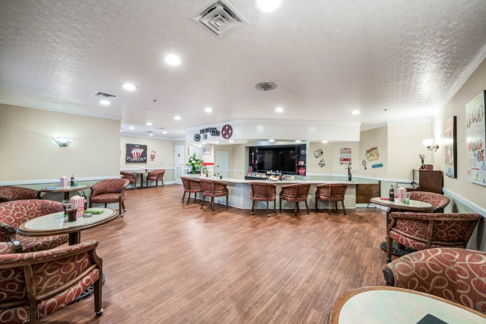 A modern lobby area with ample seating and wood flooring.