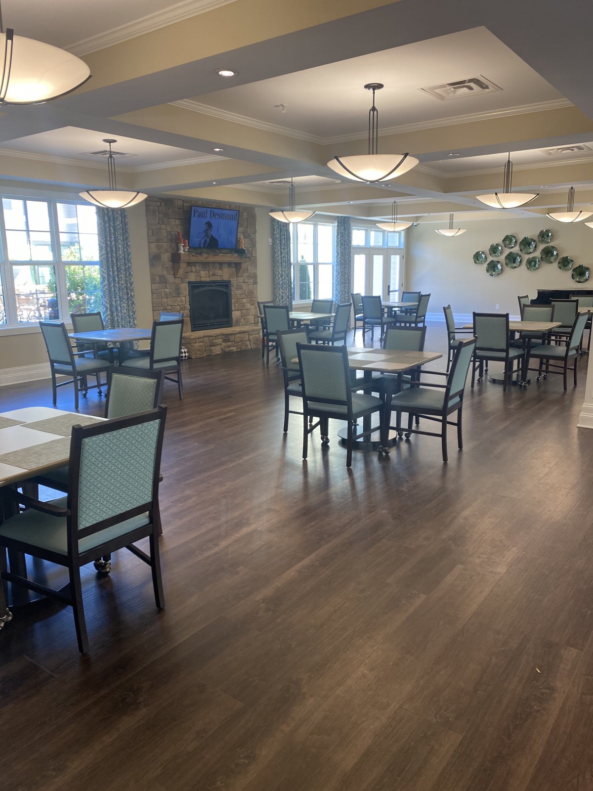 Spacious and well-lit dining area with neatly arranged tables and chairs.